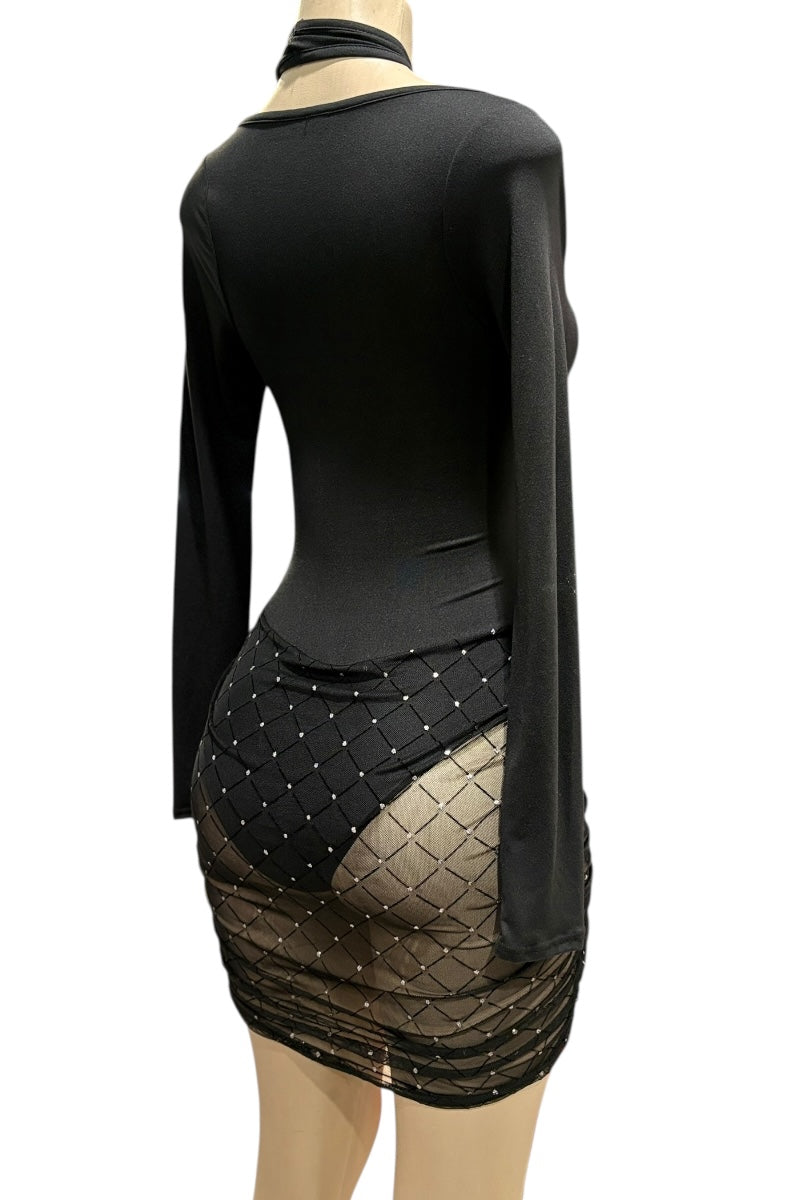 Black dress with sheer overlay on a mannequin against a white background