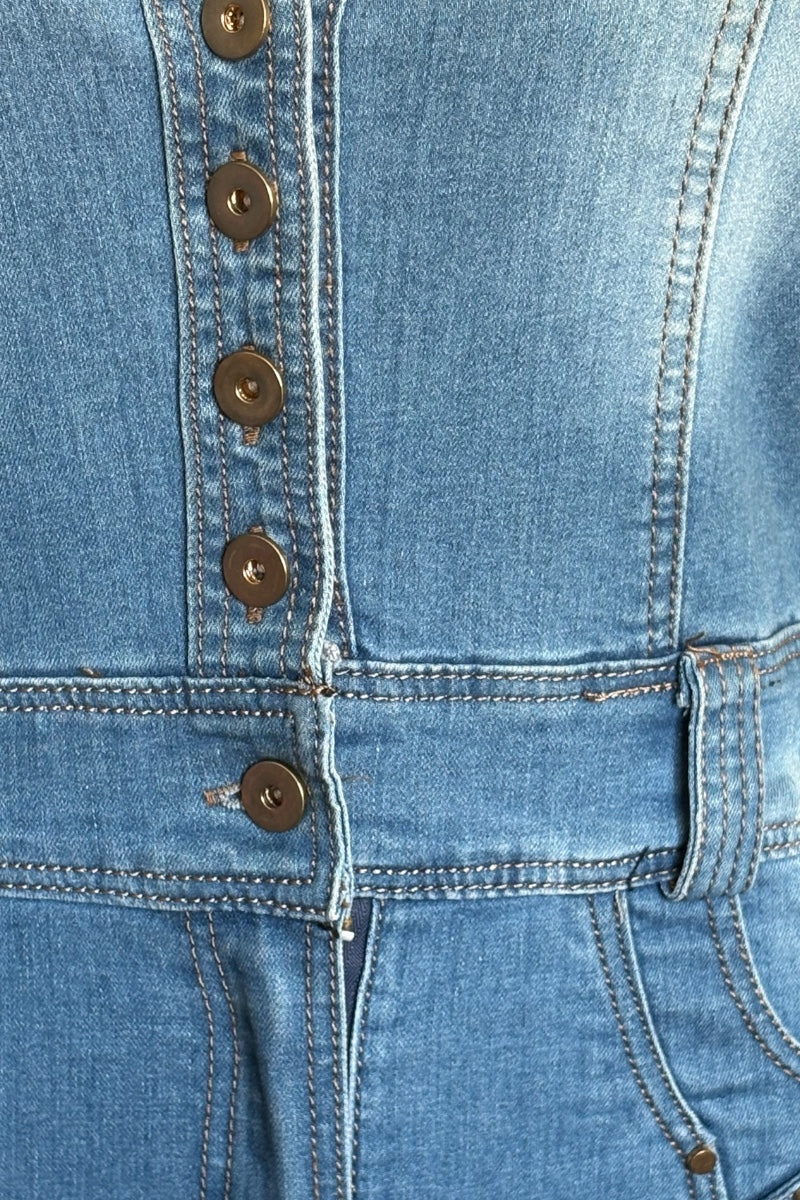 Close-up of a blue denim dress with button details