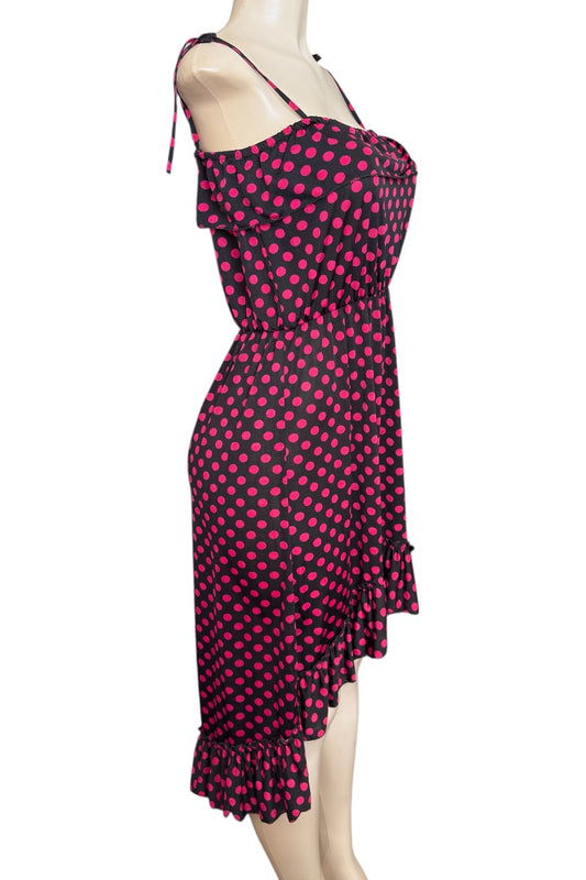 hot pink and black polka dot dress on a mannequin against a white background