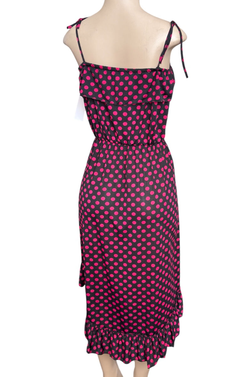 Black and pink polka dot dress on a mannequin against a white background