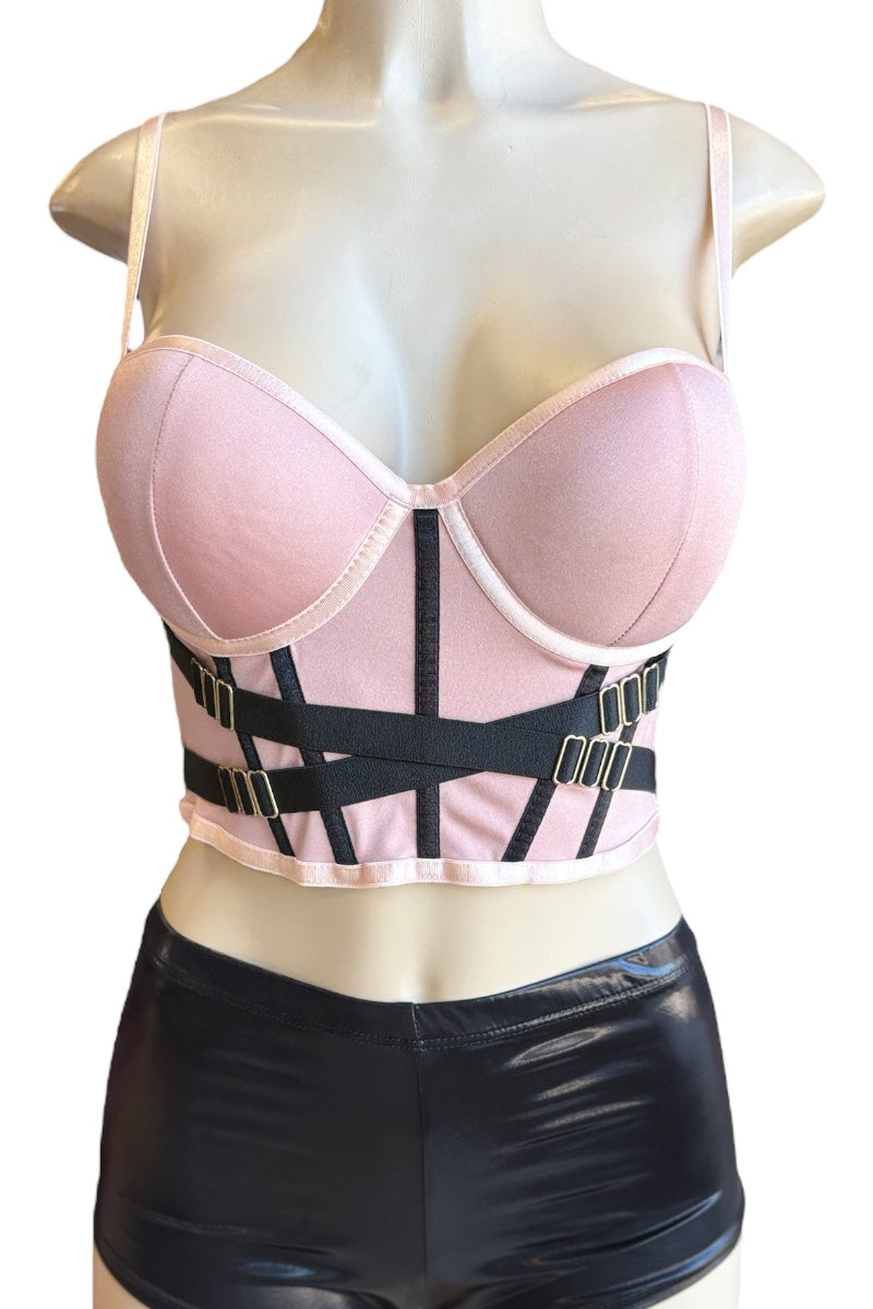 Mannequin wearing a rose top with black straps