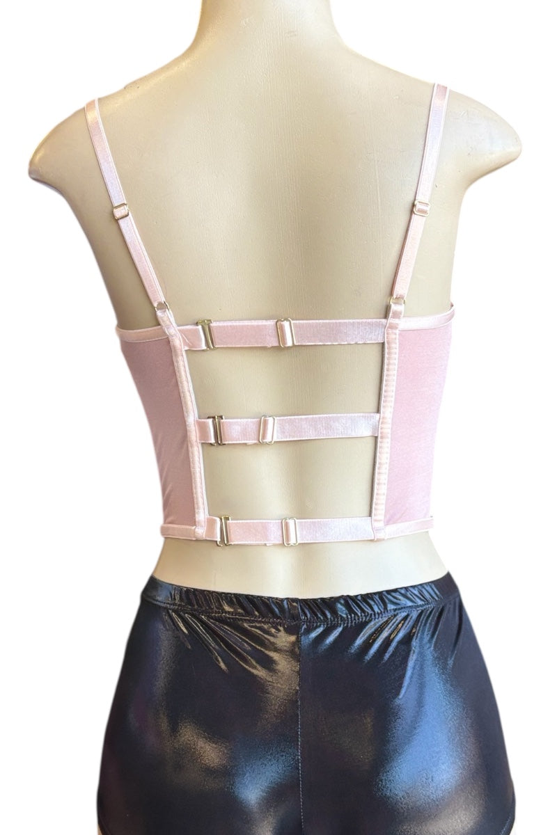 Mannequin wearing a pink corset top with black shorts on a white background
