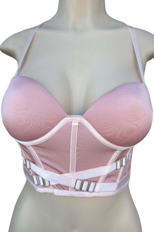 Pink crop top with straps on a mannequin against a white background