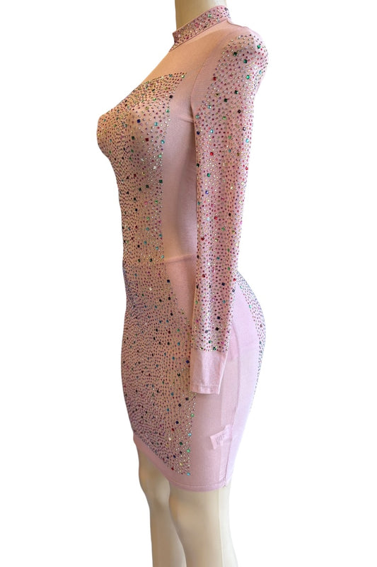 Pink sheer dress with embellishments on a mannequin against a white background