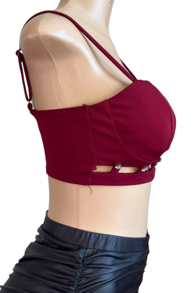 burgundy crop top with thin straps on a mannequin against a white background