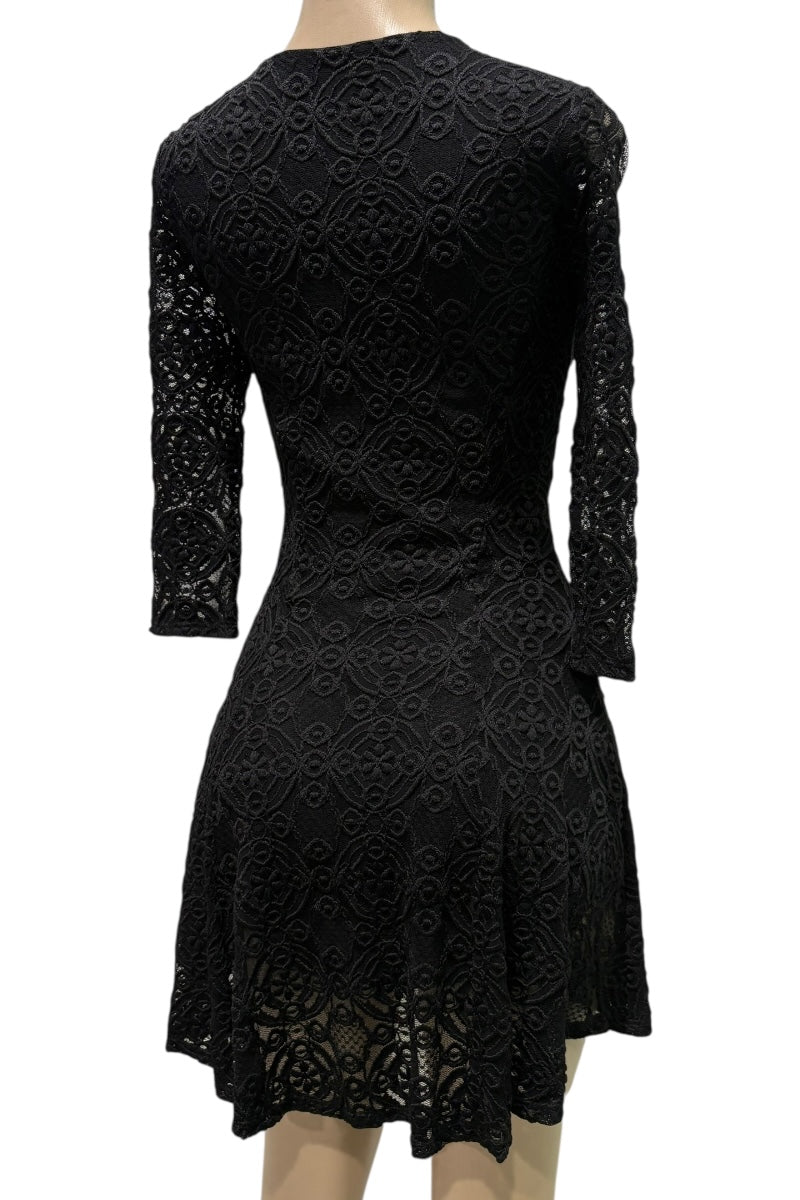 Black lace dress on a mannequin against a white background