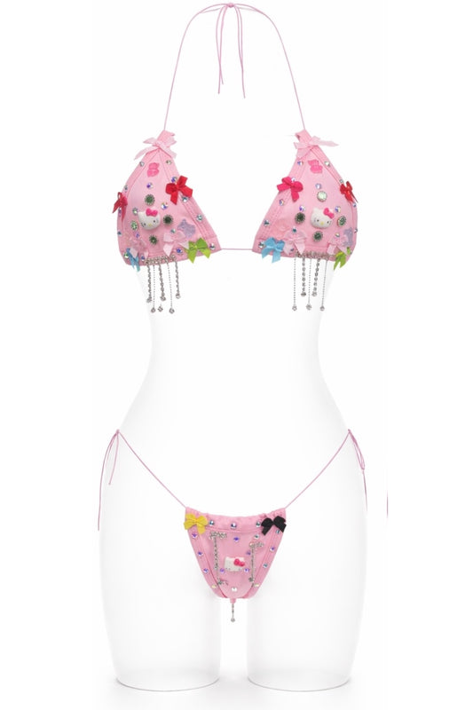 Pink bikini set with floral and bow design on a white background