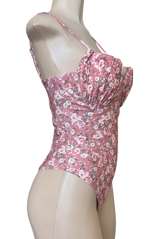 Pink floral bodysuit on a mannequin against a white background