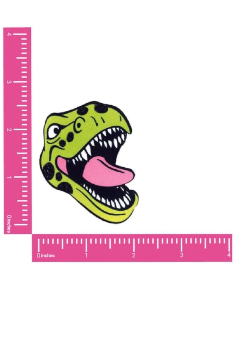Dinosaur head pasties with pink ruler on a white background
