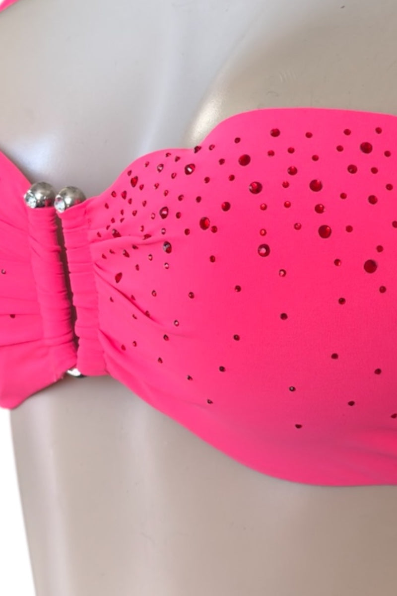 Coral bikini top with embellishments on a mannequin