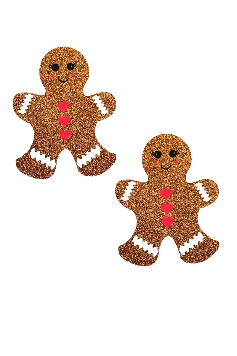 Two glittery gingerbread man decorations with red hearts on a white background