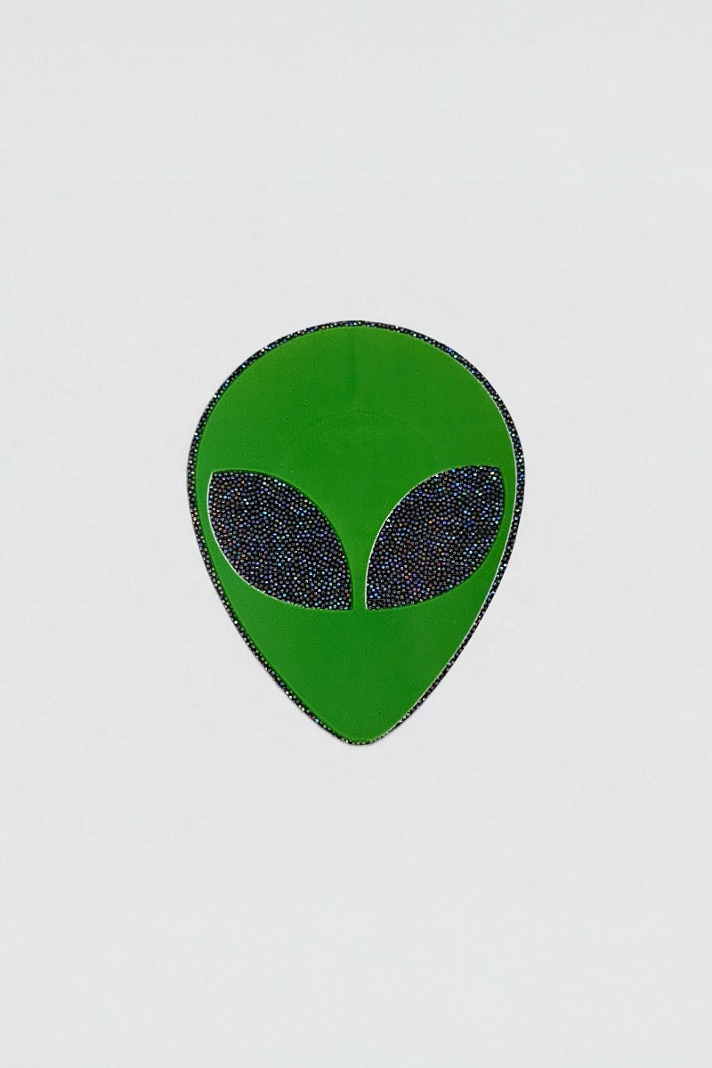 Green alien head pastie on a white background