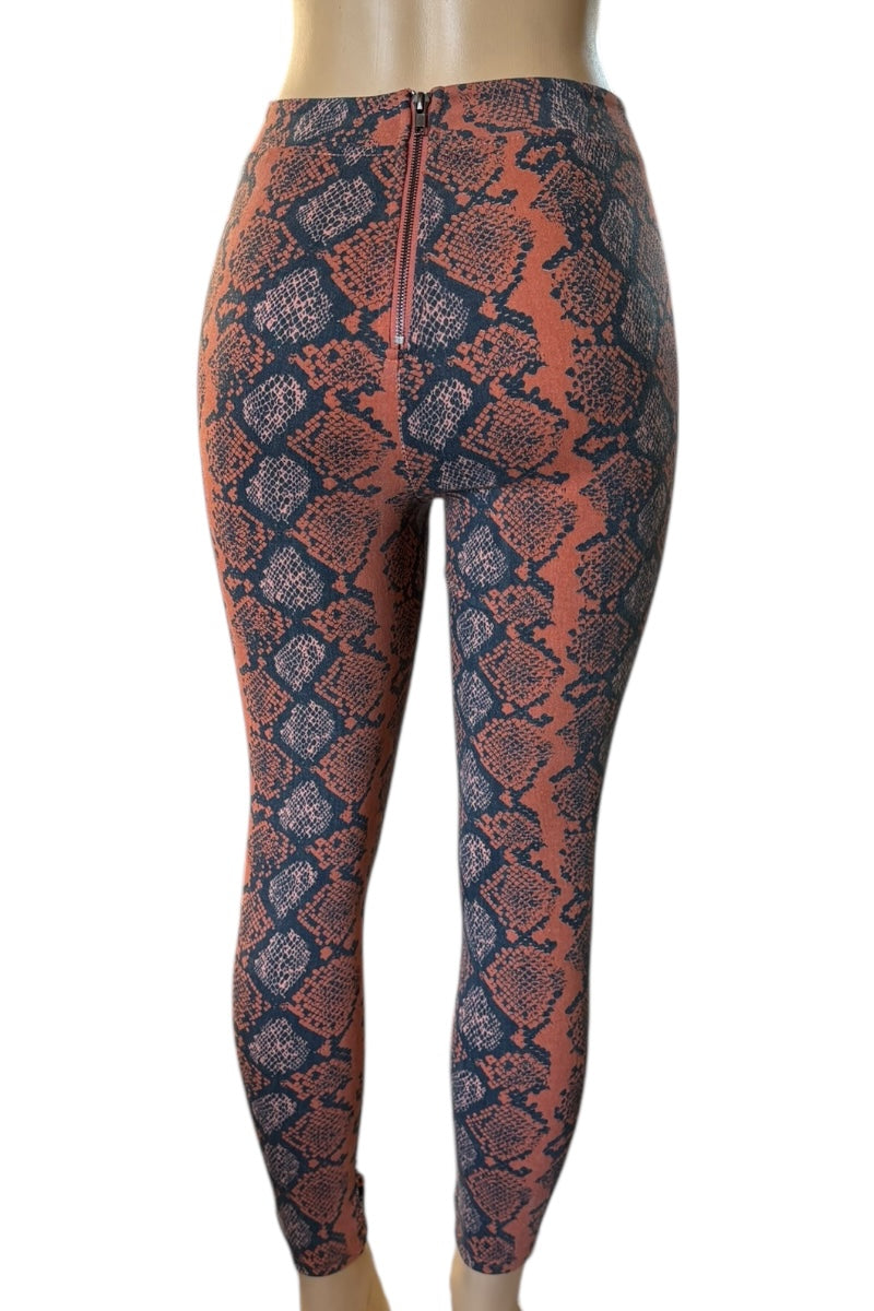 Snakeskin pattern pants on a mannequin against a white background