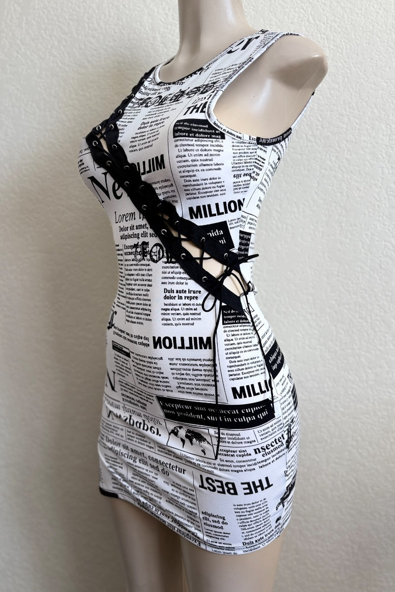 Black and white newspaper print dress on a mannequin against a plain background