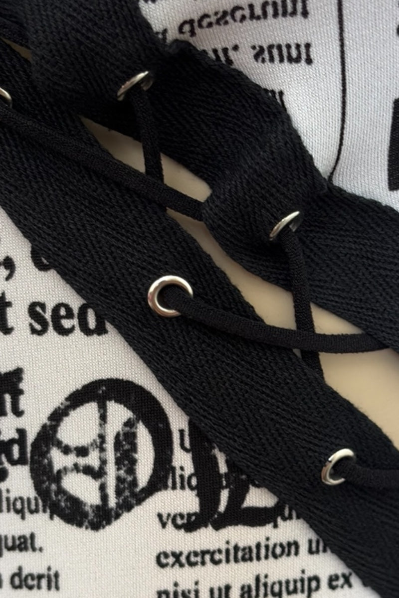 Close-up of black laces on a white surface with text