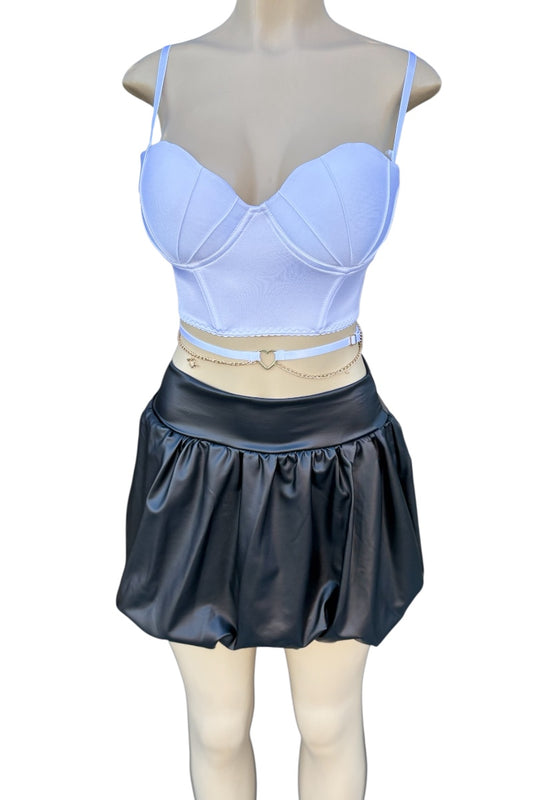 Mannequin wearing a white top and black skirt on a white background