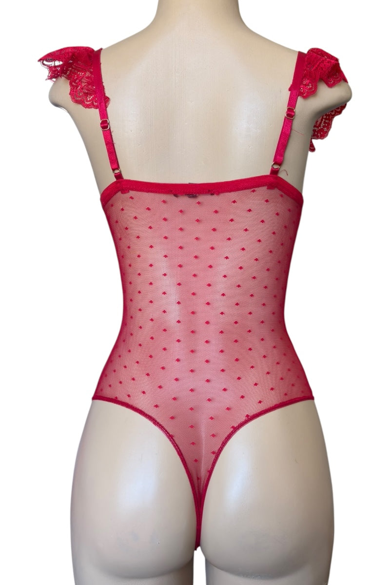 Red polka dot bodysuit with lace straps on a mannequin against a white background