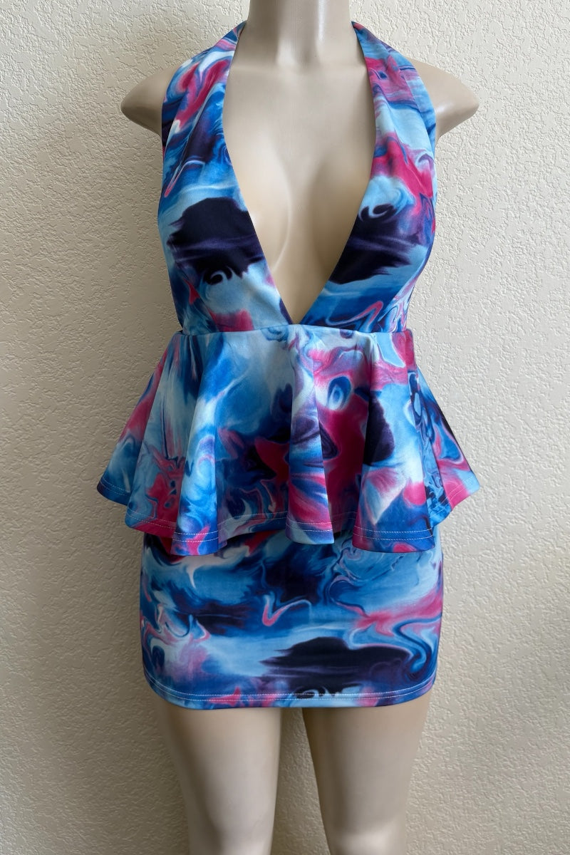 Multicolored peplum dress on a mannequin against a plain background