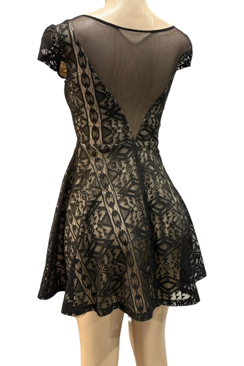 Black lace dress on a mannequin against a white background