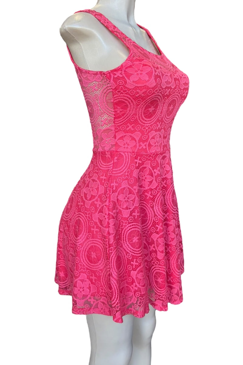Pink lace dress on a mannequin against a white background