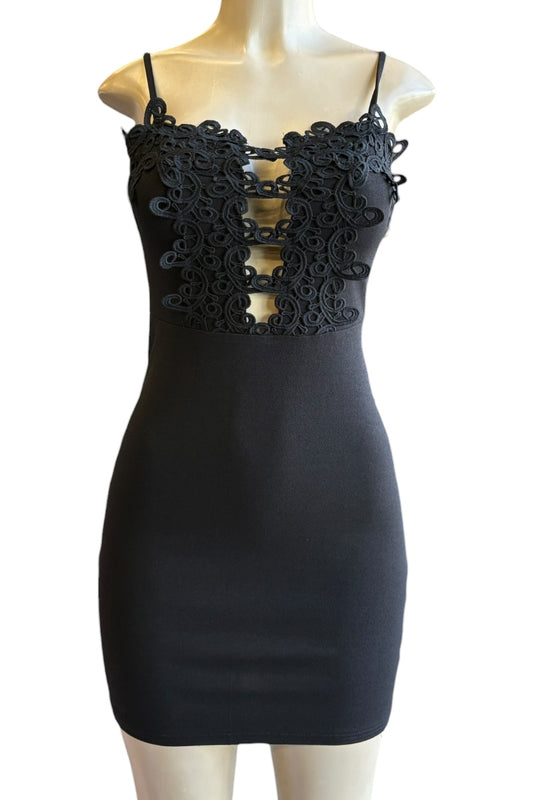Black dress with lace detailing on a mannequin against a white background