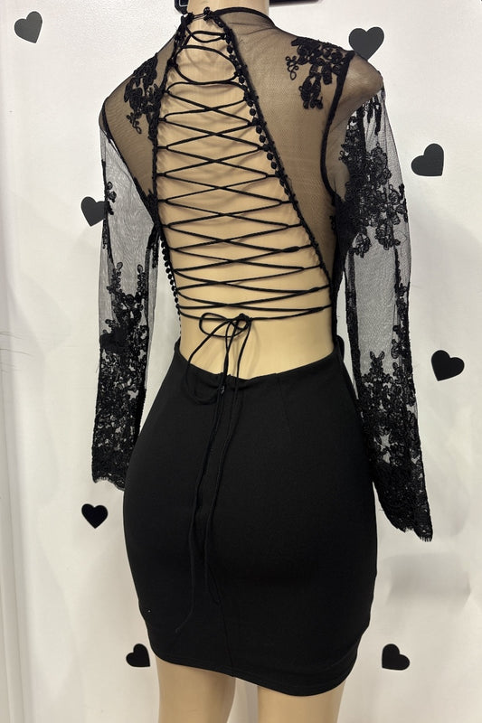 Black lace dress on a mannequin with a white background