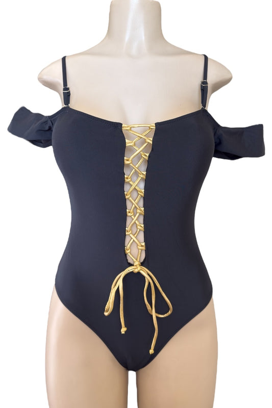 Black swimsuit with gold lace-up back on a mannequin against a white background