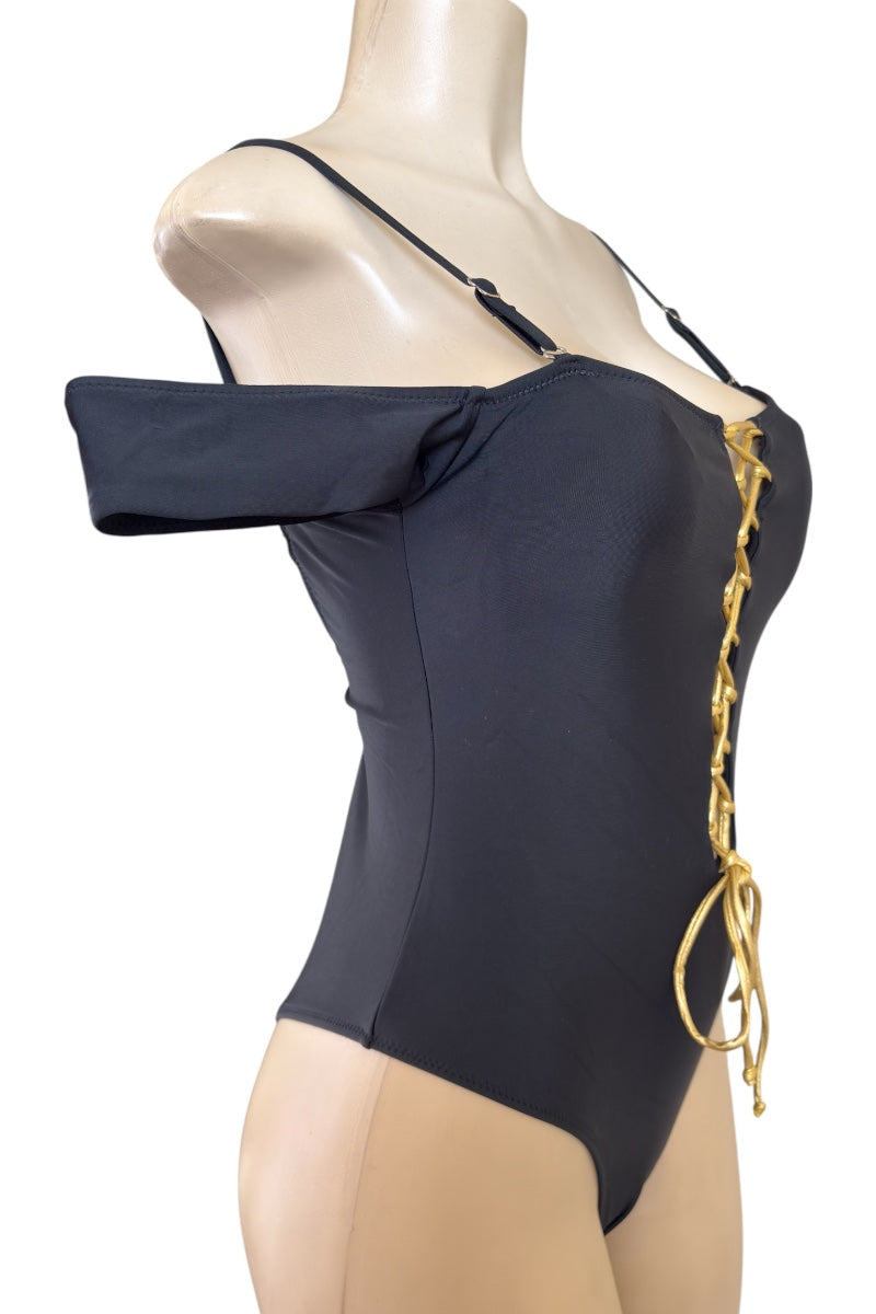 Black swimsuit with gold accents on a mannequin against a white background