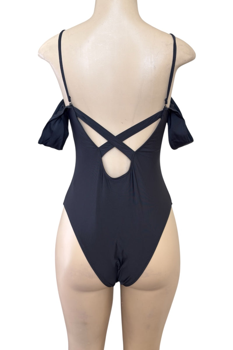 Black swimsuit with criss-cross straps on a mannequin against a white background