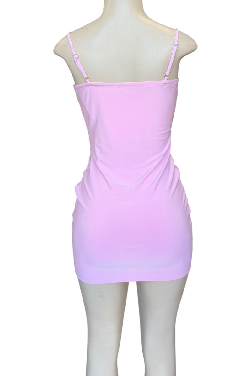 Pink dress on a mannequin against a white background