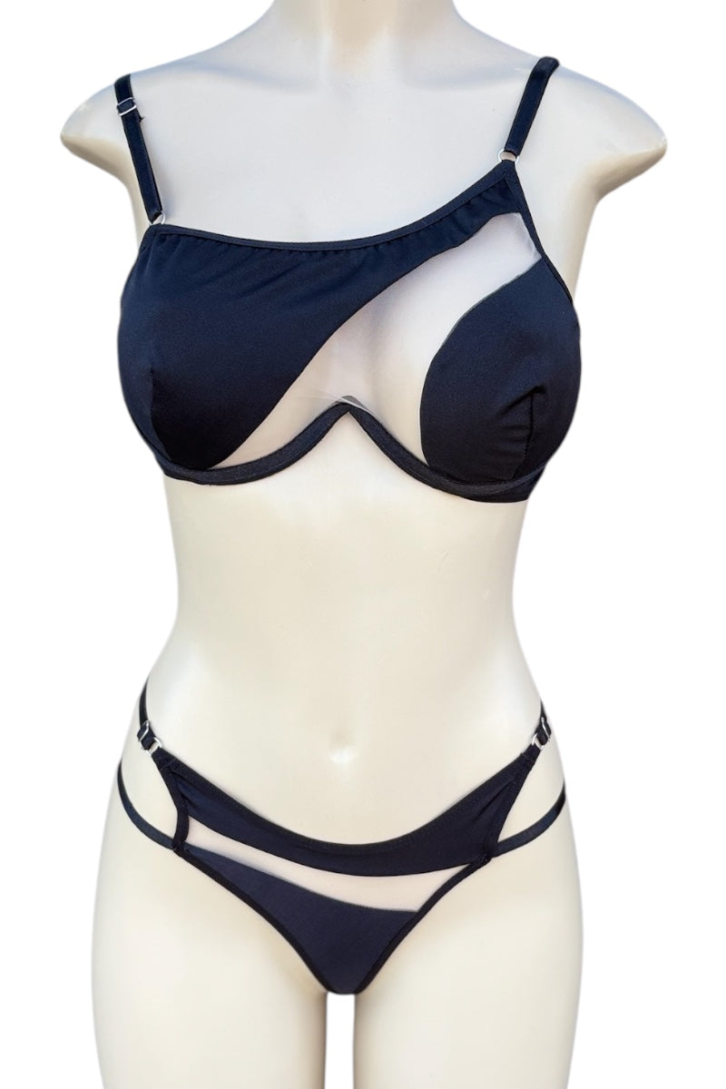 black bra top and panties set on a mannequin against a white background