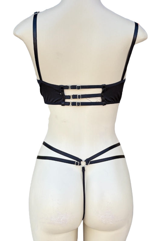 Black strappy set on a mannequin against a white background