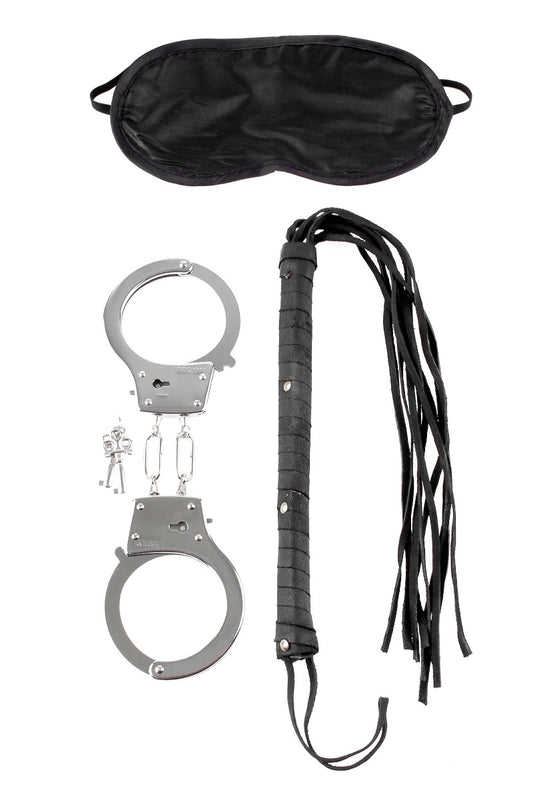 Set of handcuffs, black leather whip, and black satin eye mask on a white background