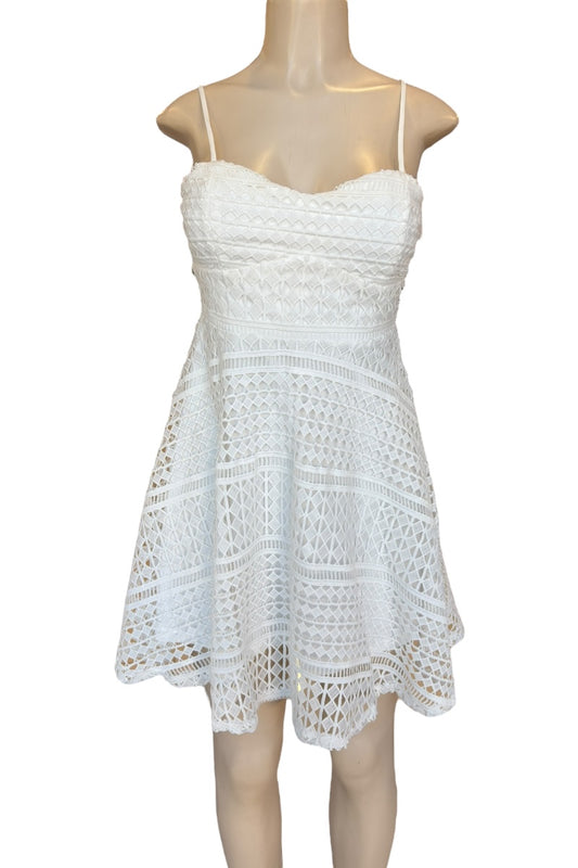 White crochet dress on a mannequin against a white background