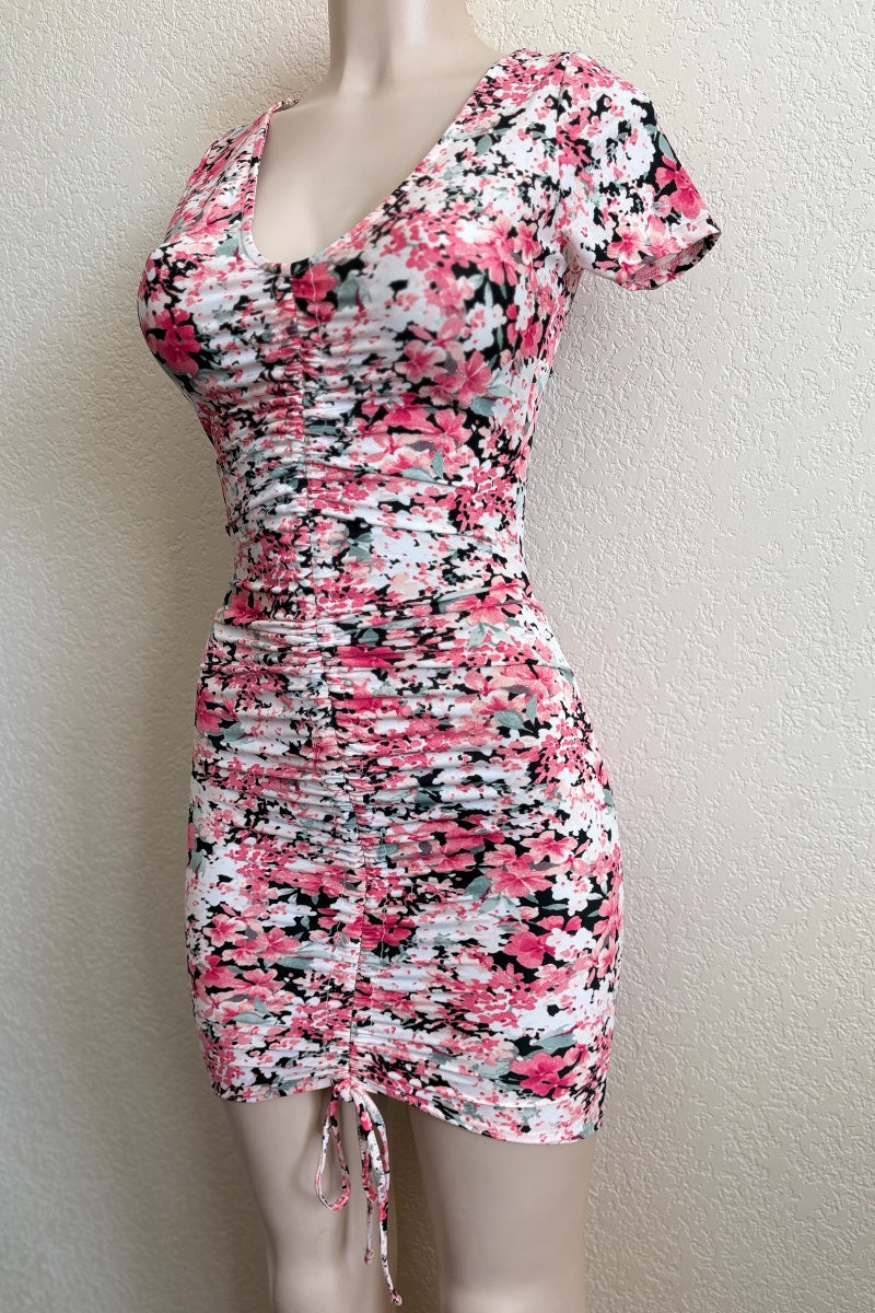 pink Floral patterned dress on a mannequin against a plain background