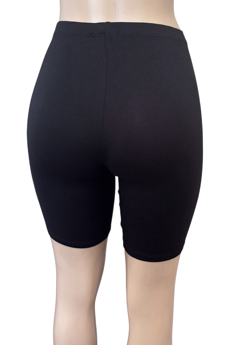 Black shorts worn by a person on a white background