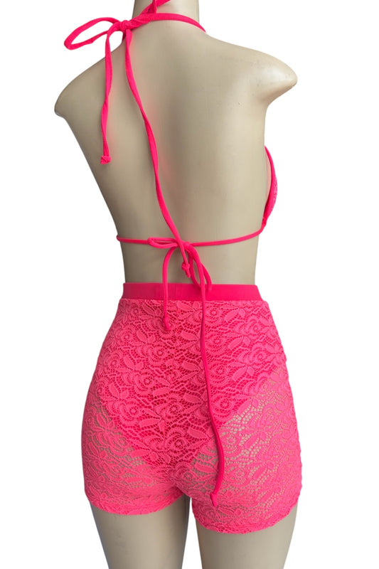 Mannequin wearing a bright pink lace two-piece swimsuit on a white background
