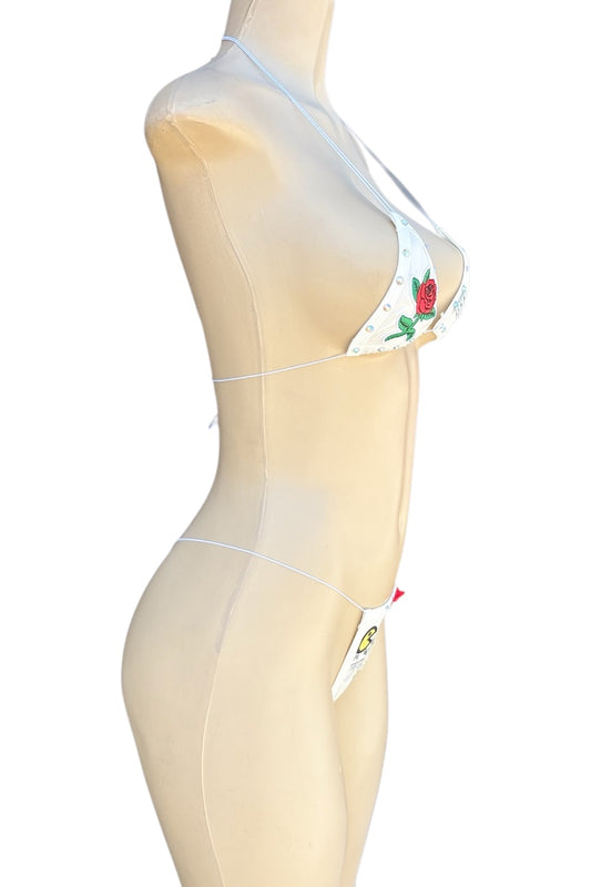 Mannequin wearing an outfit with floral embroidery on a white background