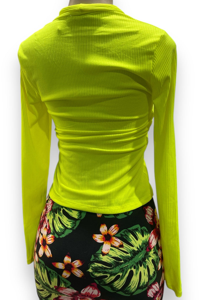 A long sleeve ribbed shirt in neon yellow color, displayed on a mannequin that has a floral skirt below it.