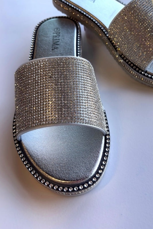 Silver sandal with rhinestone embellishments on a white background