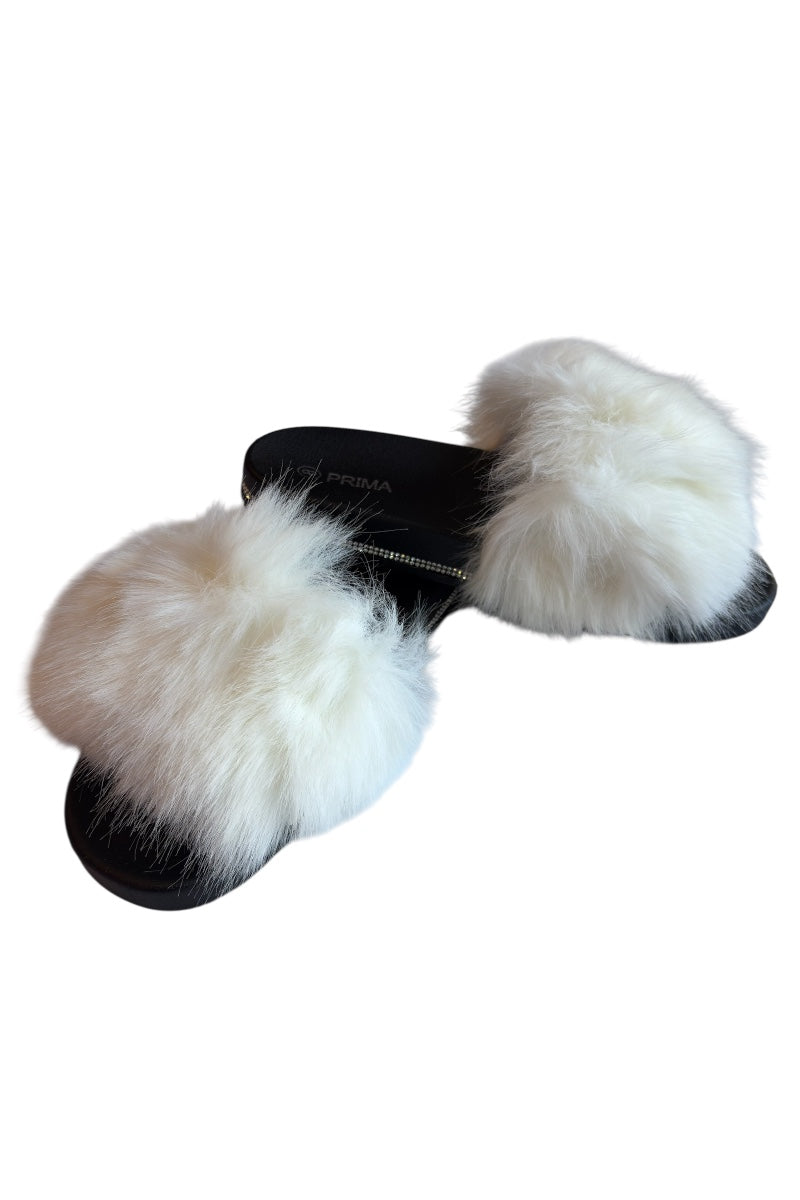 Pair of white and black furry slippers on a white background