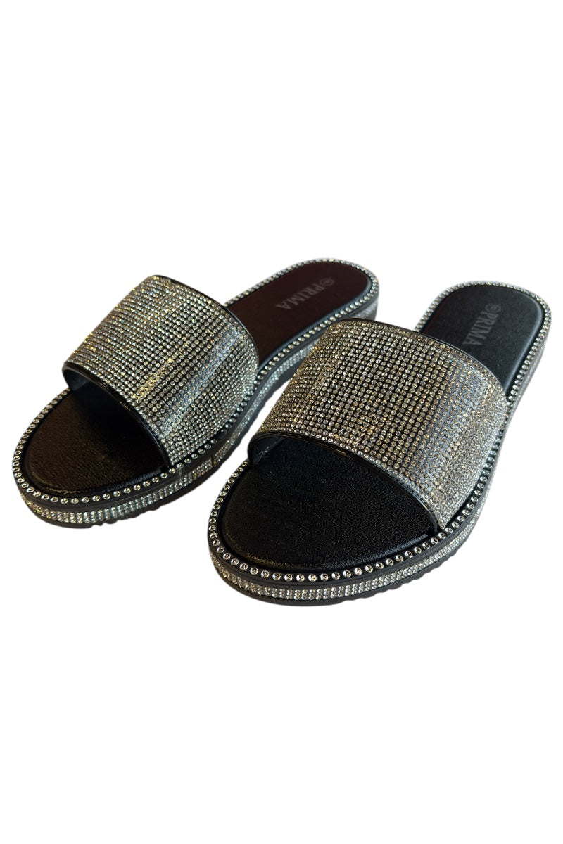 Pair of black slides with rhinestone embellishments on a white background