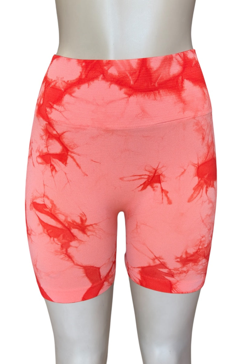 orange tie-dye shorts on a mannequin against a white background