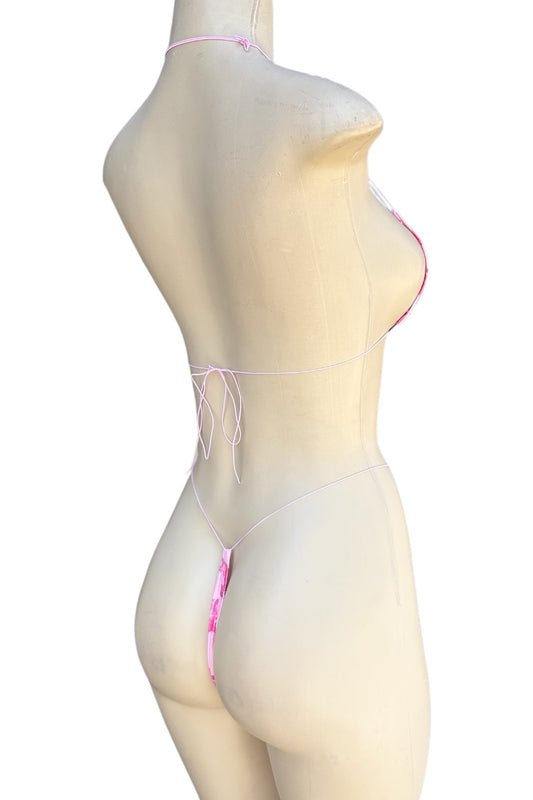 Mannequin wearing a pink lingerie set on a white background
