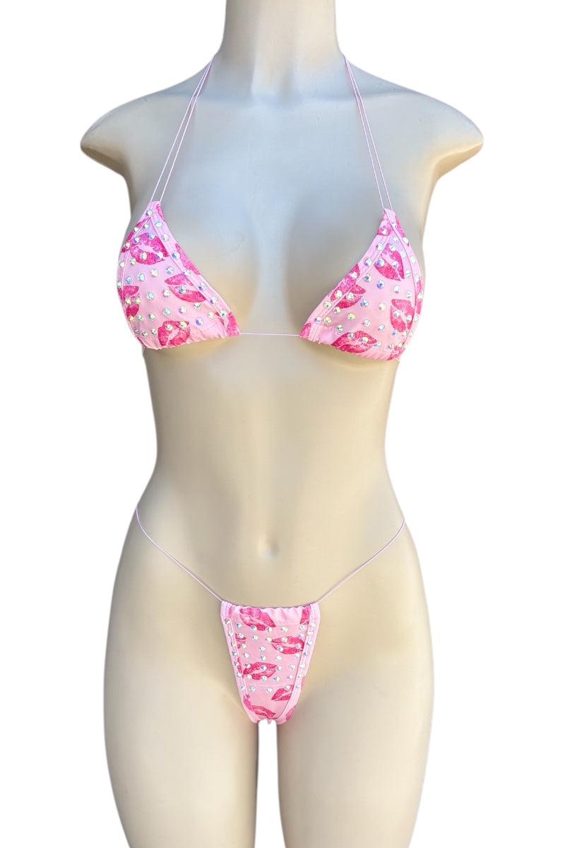 Pink kiss print bikini set on a mannequin against a white background