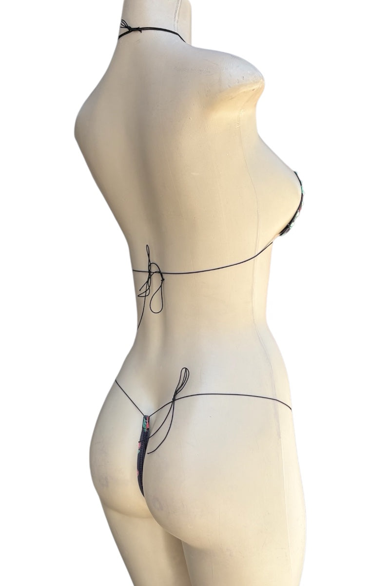 Mannequin wearing a black strappy set on a white background