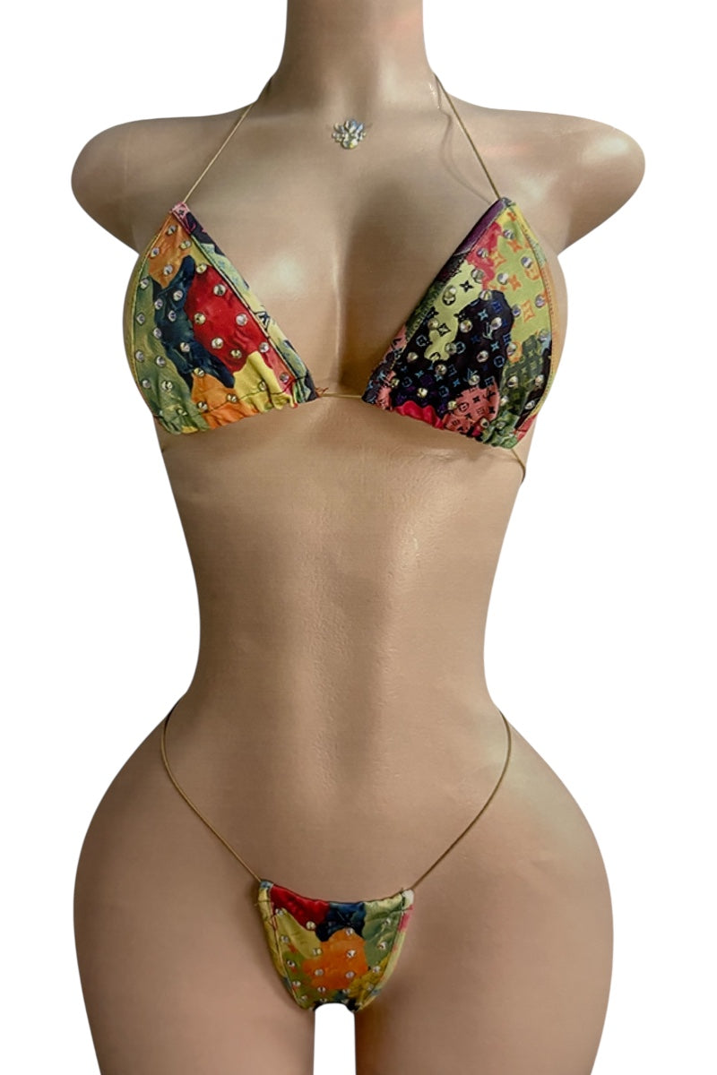 Colorful bikini set on a mannequin against a white background