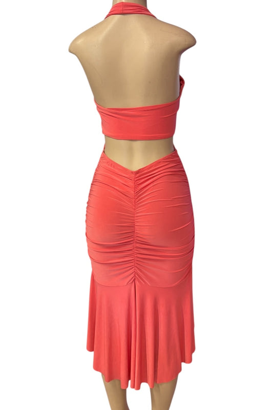 Coral two-piece dress on a mannequin against a white background