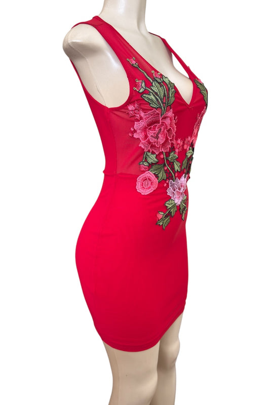 Red dress with floral embroidery on a mannequin against a white background