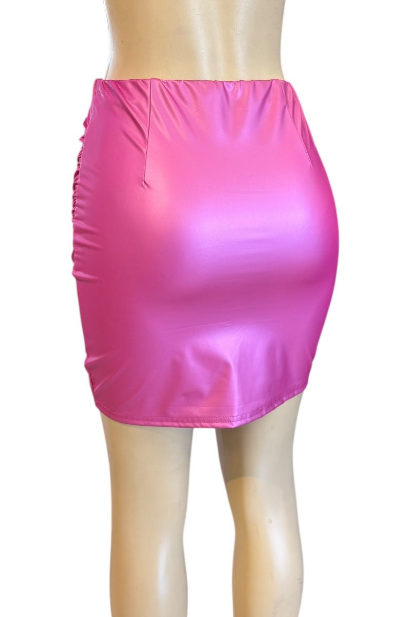 Pink shiny skirt on a mannequin against a white background